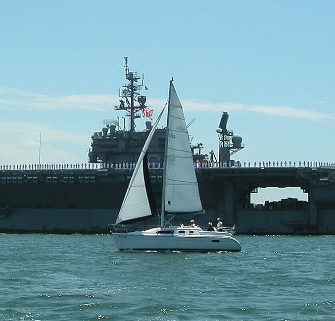 Boondoggle sailing in front of the USS Kittyhawk.