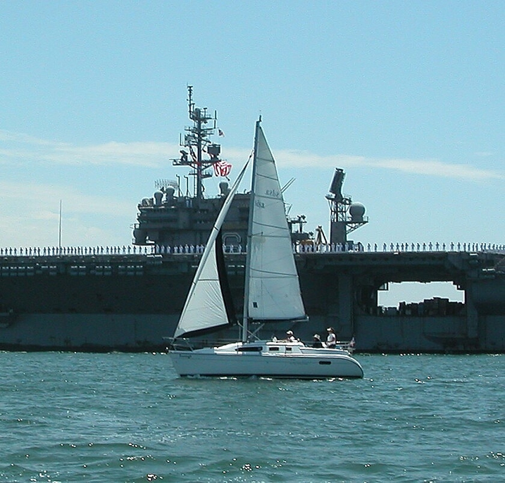 sailing in front of the USS Kittyhawk in the San Diego Harbor